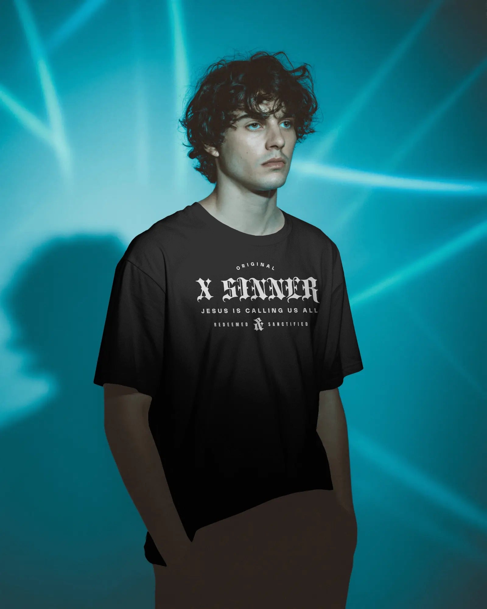 Person wearing a black t-shirt with white text against a blue light background
